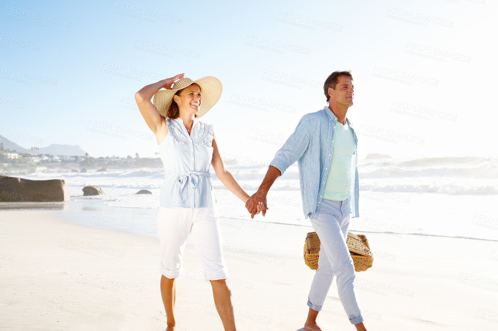 Buy stock photo A blissful couple enjoying a beautiful day on the beach together