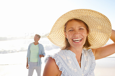 Buy stock photo Portrait of a happy woman enjoying a walk on the beach with her husband
