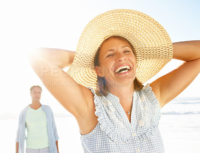 Buy stock photo An ecstatic woman enjoying a walk on the beach with her husband