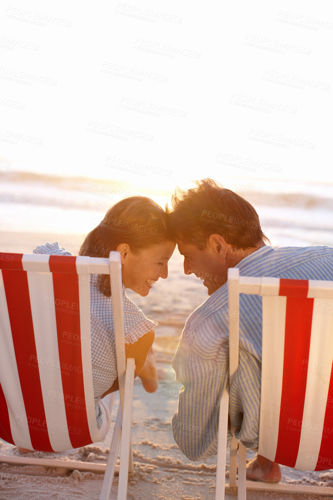 Buy stock photo Couple, back and happy on beach for travel, bonding and tropical holiday on anniversary date with sunshine. Man, woman and connection by ocean for relax, love and vacation trip with chair in Maldives