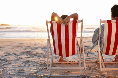 Buy stock photo Couple, back and sunset on beach for travel, bonding and tropical holiday on anniversary date with sunshine. Man, woman and relax by ocean for romance, love and vacation trip with chair in Maldives