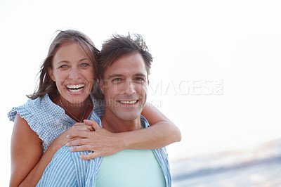 Buy stock photo A blissful mature couple embracing alongside copyspace on the beach