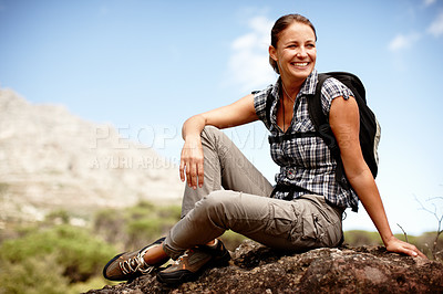 Buy stock photo Attractive female hiker smiling while resting on a mountain top