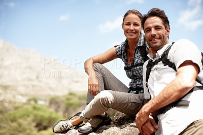 Buy stock photo Two hikers smiling while enjoying a mountain top view