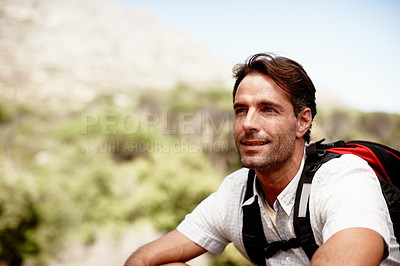 Buy stock photo Handsome male hiker smiling while seated on a mountain top