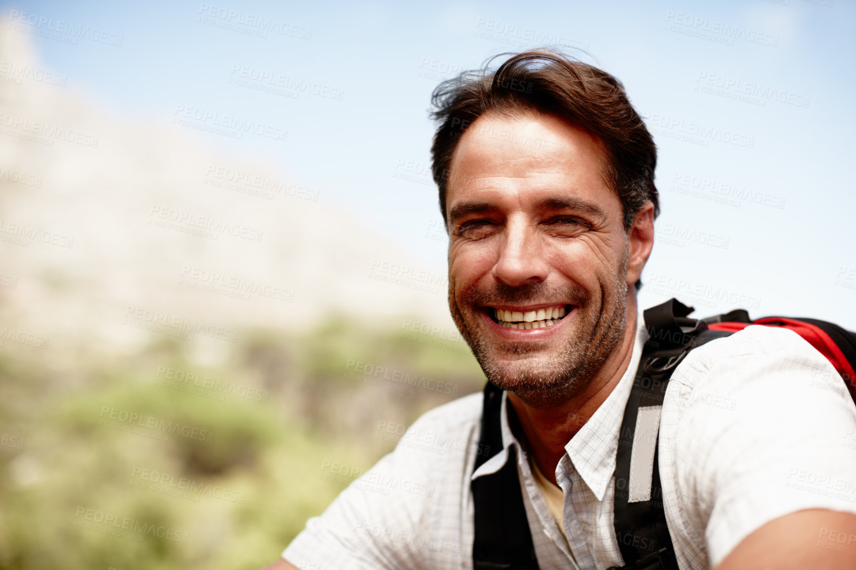 Buy stock photo Relax, hiking and portrait of man on mountain top with smile, peace and fitness on holiday adventure for travel. Break, happy and calm hiker on hill with backpack, rest and outdoor vacation in nature