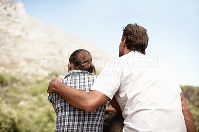 Buy stock photo Rear view of a couple out enjoying a mountain view after a hike
