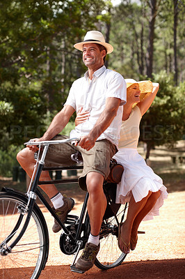 Buy stock photo Couple, vintage fashion or riding bicycle in countryside for transportation, travel or forest adventure. People, happy and trip on retro bike backseat in nature for recreation, explore or sightseeing