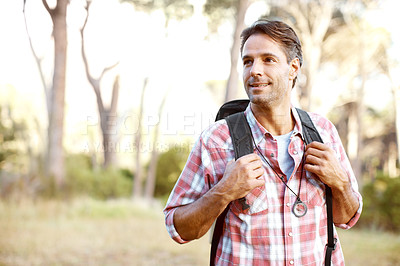 Buy stock photo A handsome young man wearing a backpack while outdoors