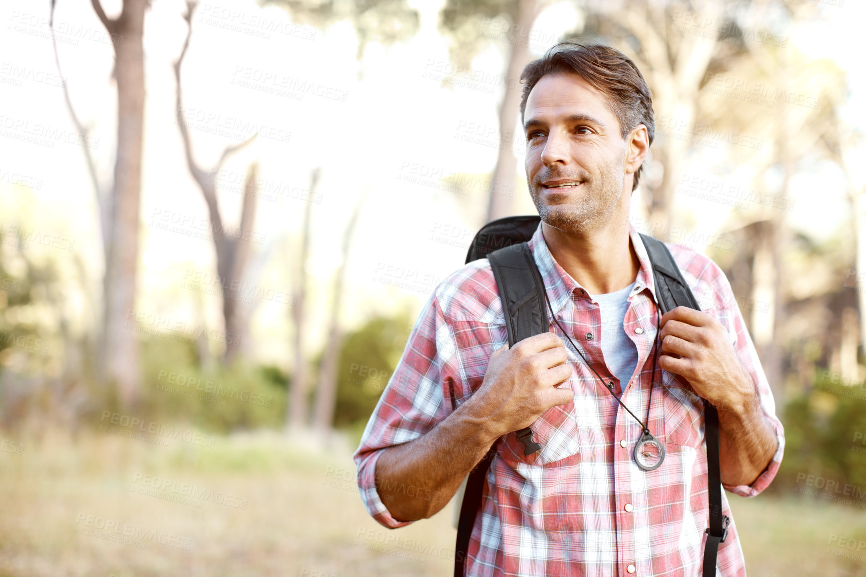 Buy stock photo A handsome young man wearing a backpack while outdoors