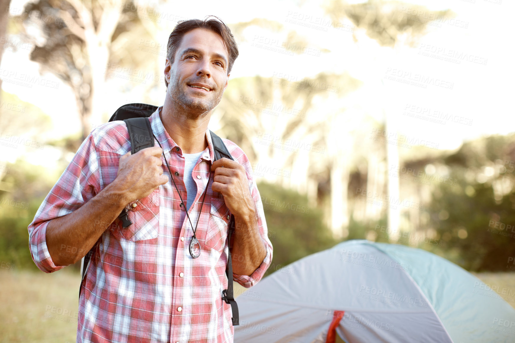 Buy stock photo Man, thinking and backpack for camping, outdoor and smile with perspective, adventure and journey in summer. Person, happy and memory with direction, back and tent for vacation with sunshine in Italy