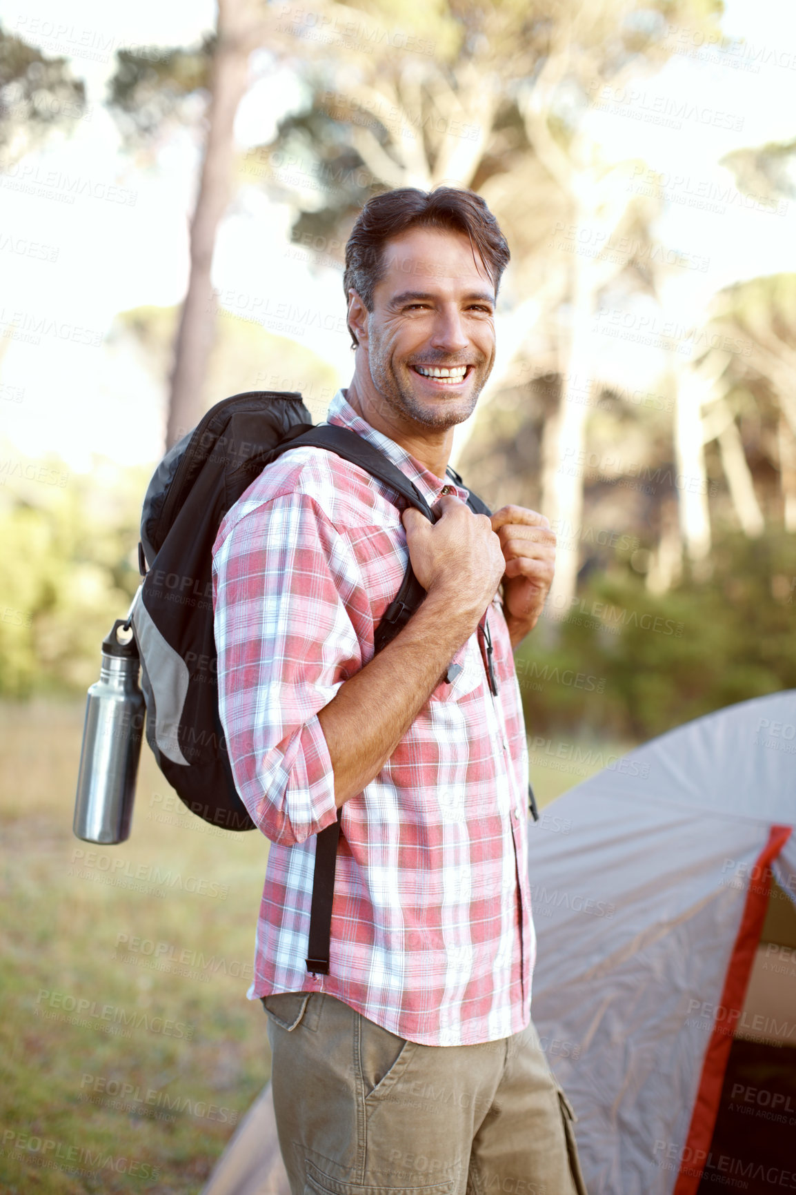 Buy stock photo Man, portrait and smile by tent for camping, backpack and outdoor with pride, adventure and journey in summer. Person, happy and bag with direction, travel and sunshine with vacation in Costa Rica