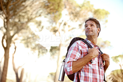 Buy stock photo A handsome young man appreciating nature while backpacking