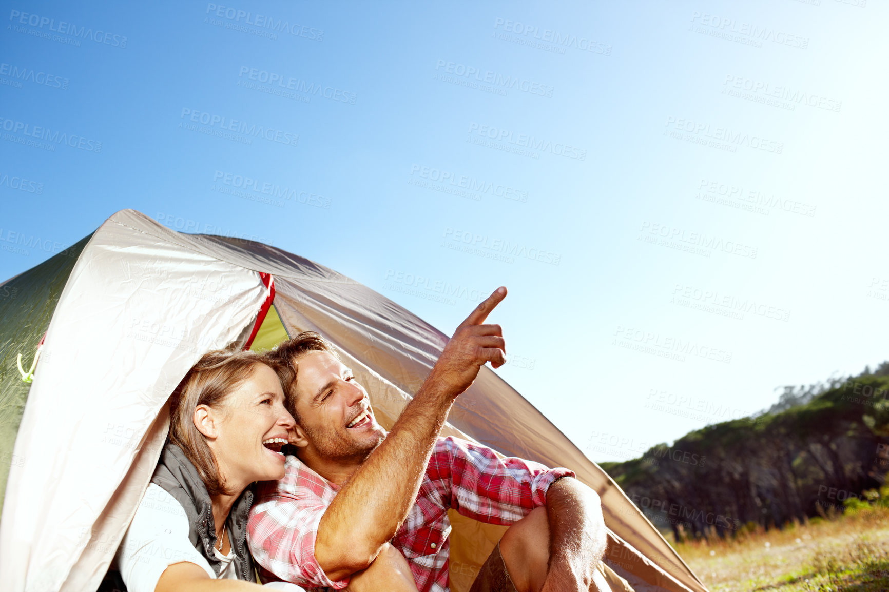 Buy stock photo Couple, camping and point by tent, smile and holiday with memory, sky and mock up space in countryside. People, man and woman in morning with adventure, vacation and laughing outdoor in Argentina