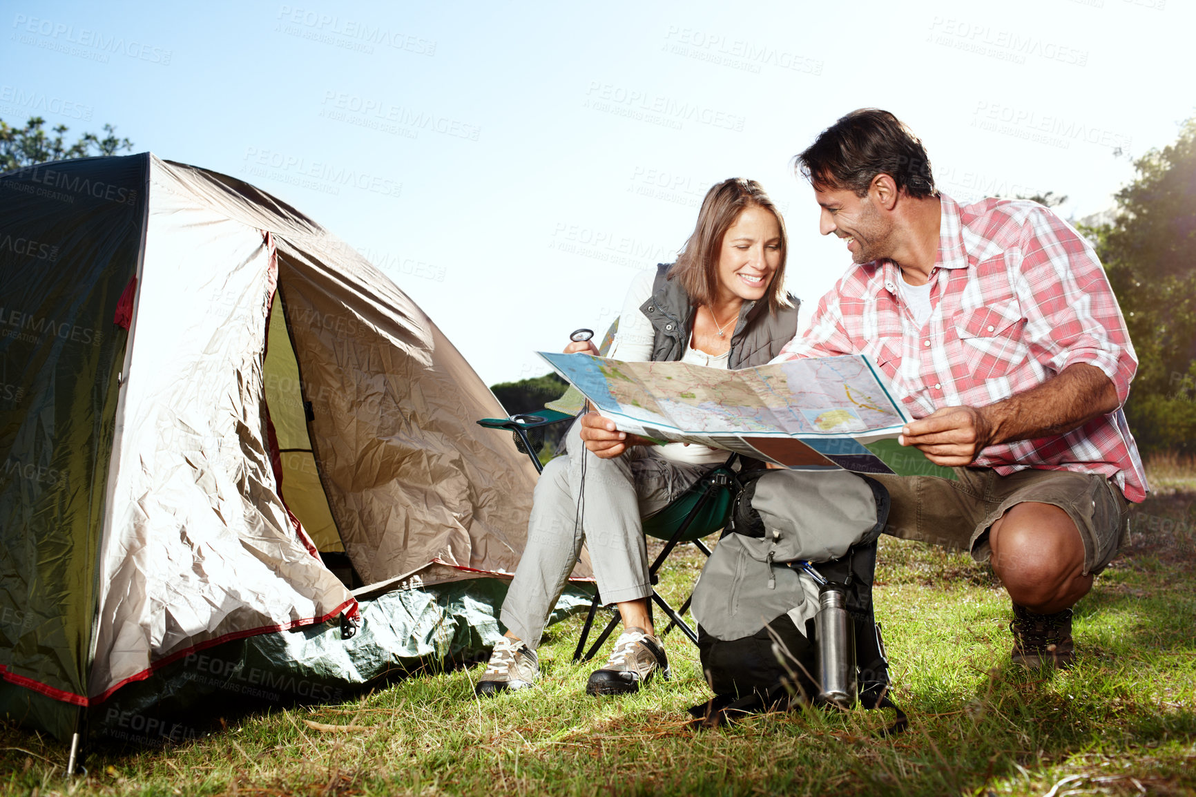 Buy stock photo A young couple looking at their destination on a map