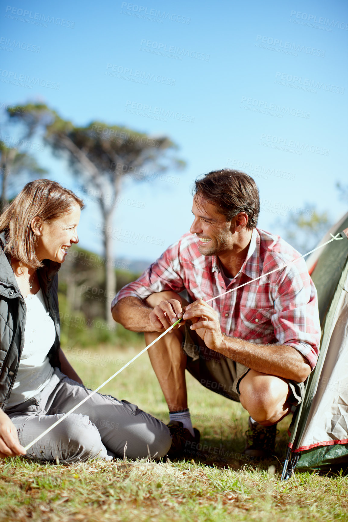 Buy stock photo Love, couple and pitch tent for camping in holiday adventure, explore nature and bonding together. Happy people, man and woman with rope for shelter preparation, setting up and support for assemble