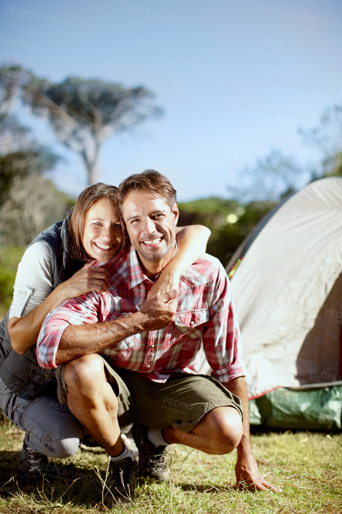 Buy stock photo Portrait of a loving young couple enjoying the outdoors together