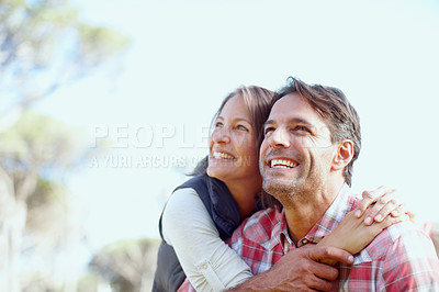 Buy stock photo A young smiling couple looking up