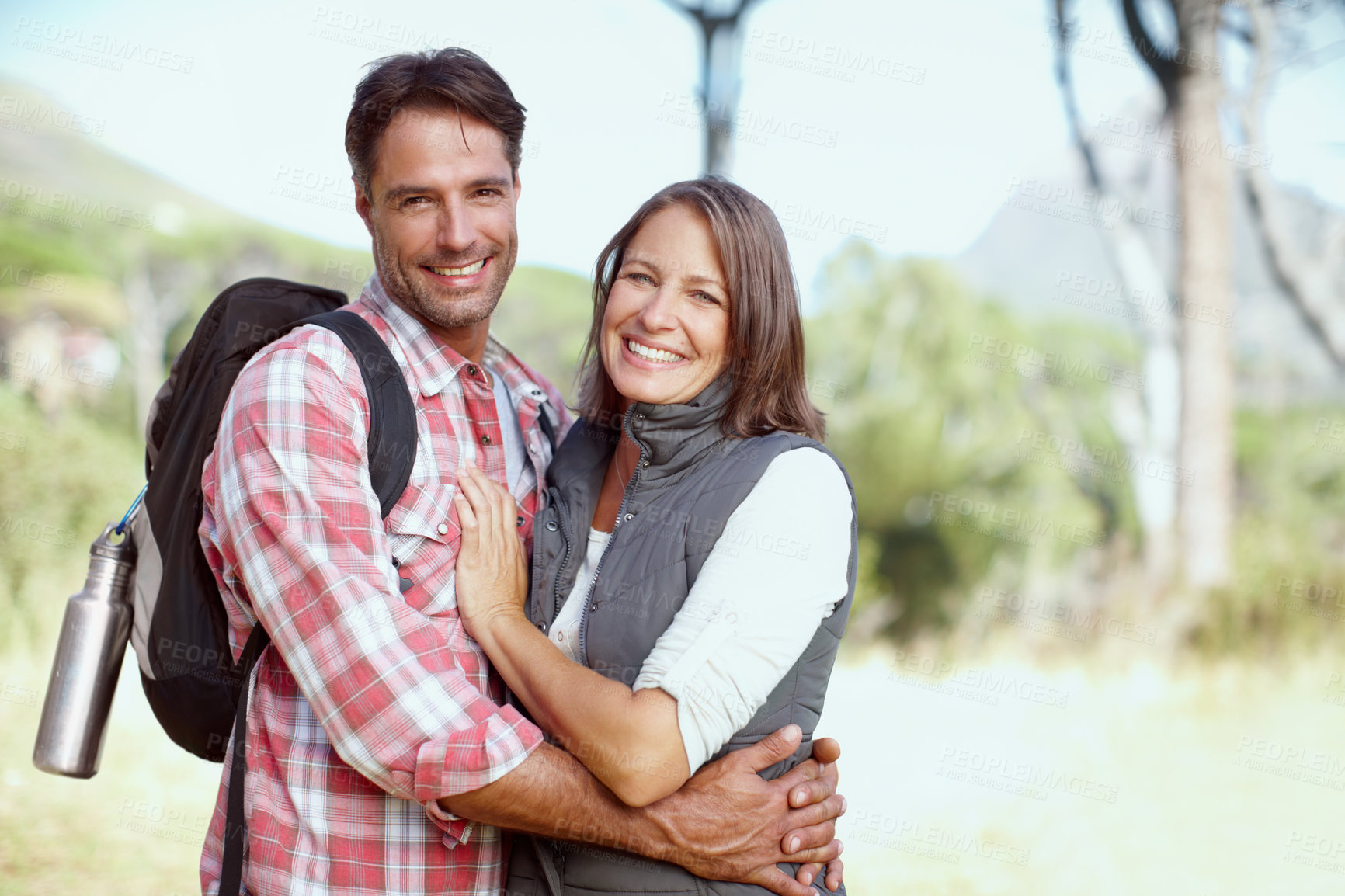 Buy stock photo A young couple posing with their hiking gear