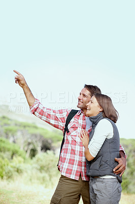 Buy stock photo Couple, sightseeing and outdoor hug on hike, conversation and adventure in Costa Rica. People, pointing and support relationship by trekking in nature, embrace journey and together for view in woods