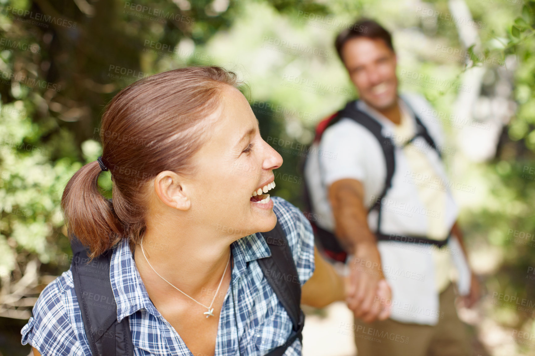 Buy stock photo Happy woman, laughing or couple in woods for hiking, adventure or travel journey on break in nature. Funny, smile or face of people in Italy holding hands for holiday trip or trekking to explore park