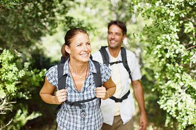 Buy stock photo A young couple hiking in a park