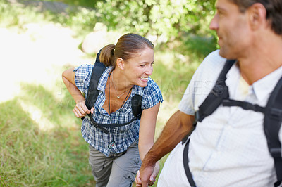 Buy stock photo Couple, fitness and holding hands in nature for hiking, happy and adventure with bonding and support. Man, woman and love outdoor for exercise, health and trekking with journey, travel and walking