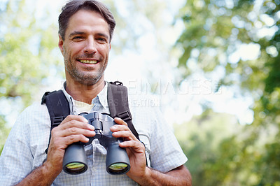 Buy stock photo Portrait of a young man holding binoculars