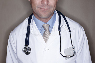 Buy stock photo Employee, man and doctor with stethoscope in studio background for healthcare, heartbeat and support. Male person, medicine and isolated as medical professional with confidence as cardiologist