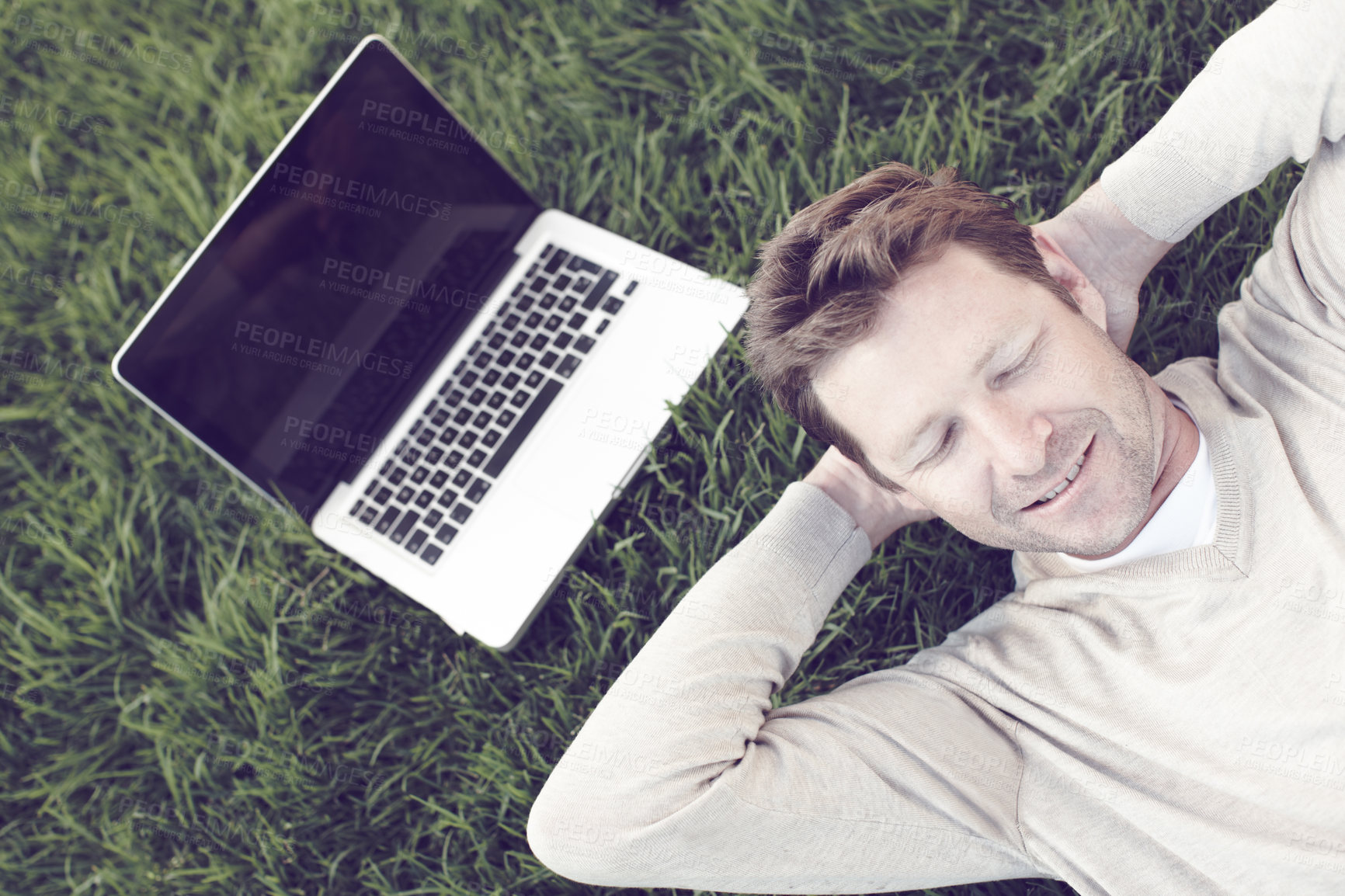 Buy stock photo Above, man and relax or sleeping on grass for nature peace, calm morning and travel destination in countryside. Male person, rest and nap with laptop for summer break, environment comfort and dream