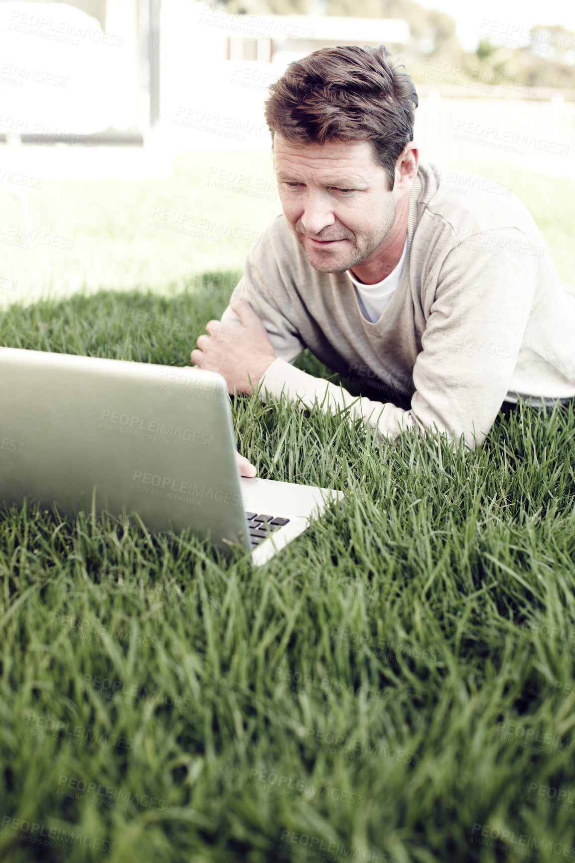 Buy stock photo Man, outdoor and laptop for remote work, online and backyard lawn for copywriting website article. Male person, nature and freelance writer to update column, communication and internet for news