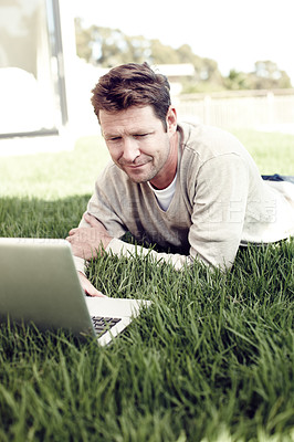 Buy stock photo Man, outdoor and laptop for remote work, planning and backyard lawn for copywriting website article. Male person, nature and freelance writer to update column, communication and internet for news