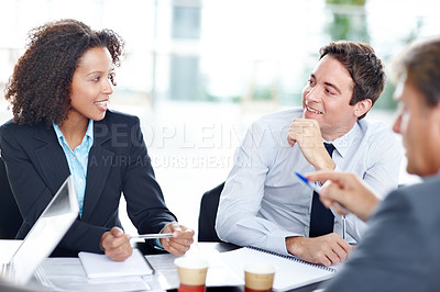 Buy stock photo Smiling business colleagues sitting and having a meeting
