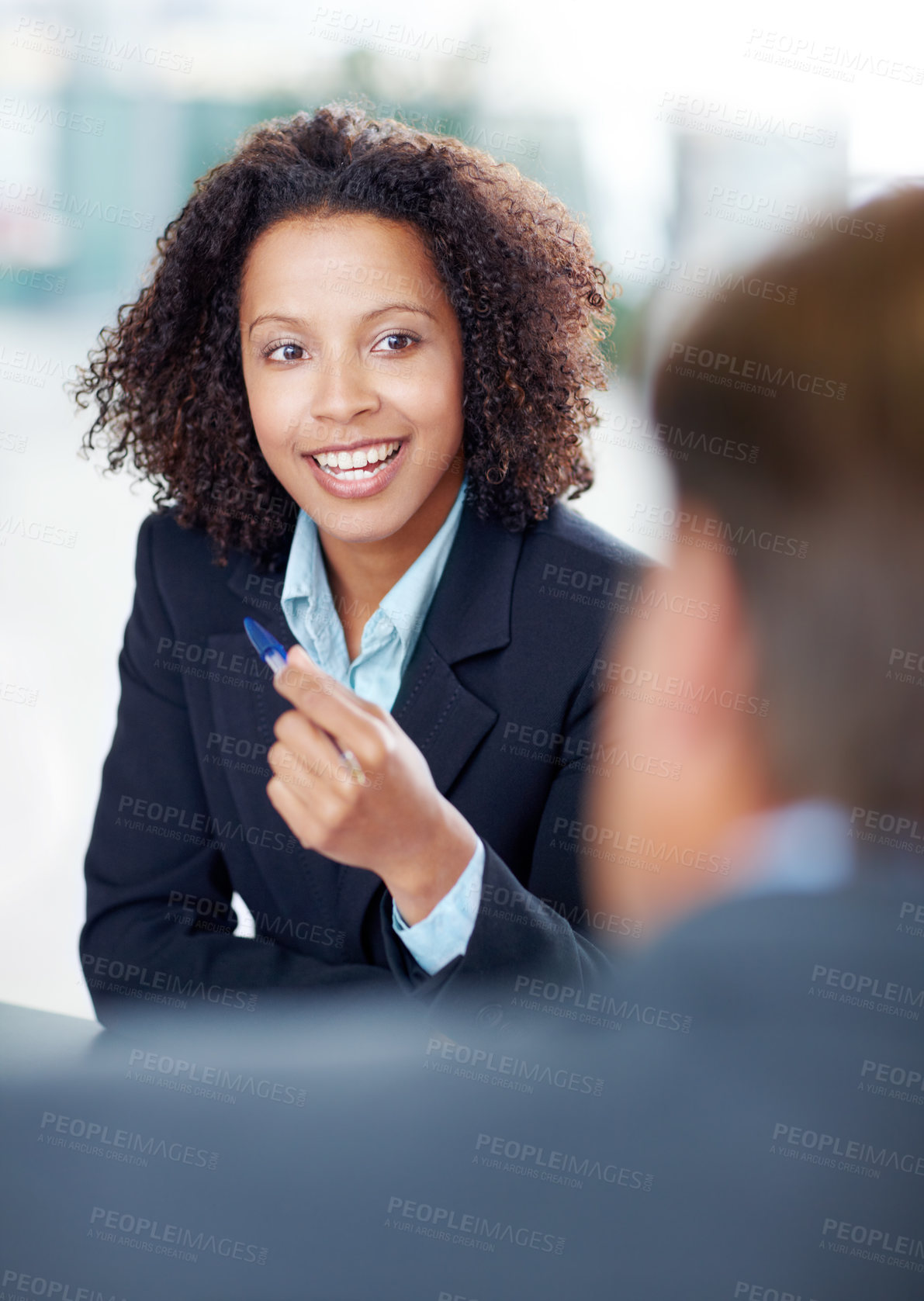 Buy stock photo Pretty businesswoman sitting in a meeting with her coworkers