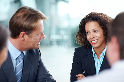 Buy stock photo Mature businessman having a meeting with his younger colleagues