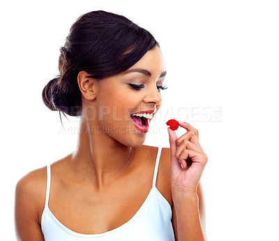 Buy stock photo Studio shot of a young woman in gymwear holding a raspberry