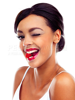 Buy stock photo A young woman in gymwear biting a raspberry and winking at the camera