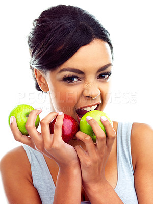 Buy stock photo Studio portrait of a young woman in gymwear holding apples