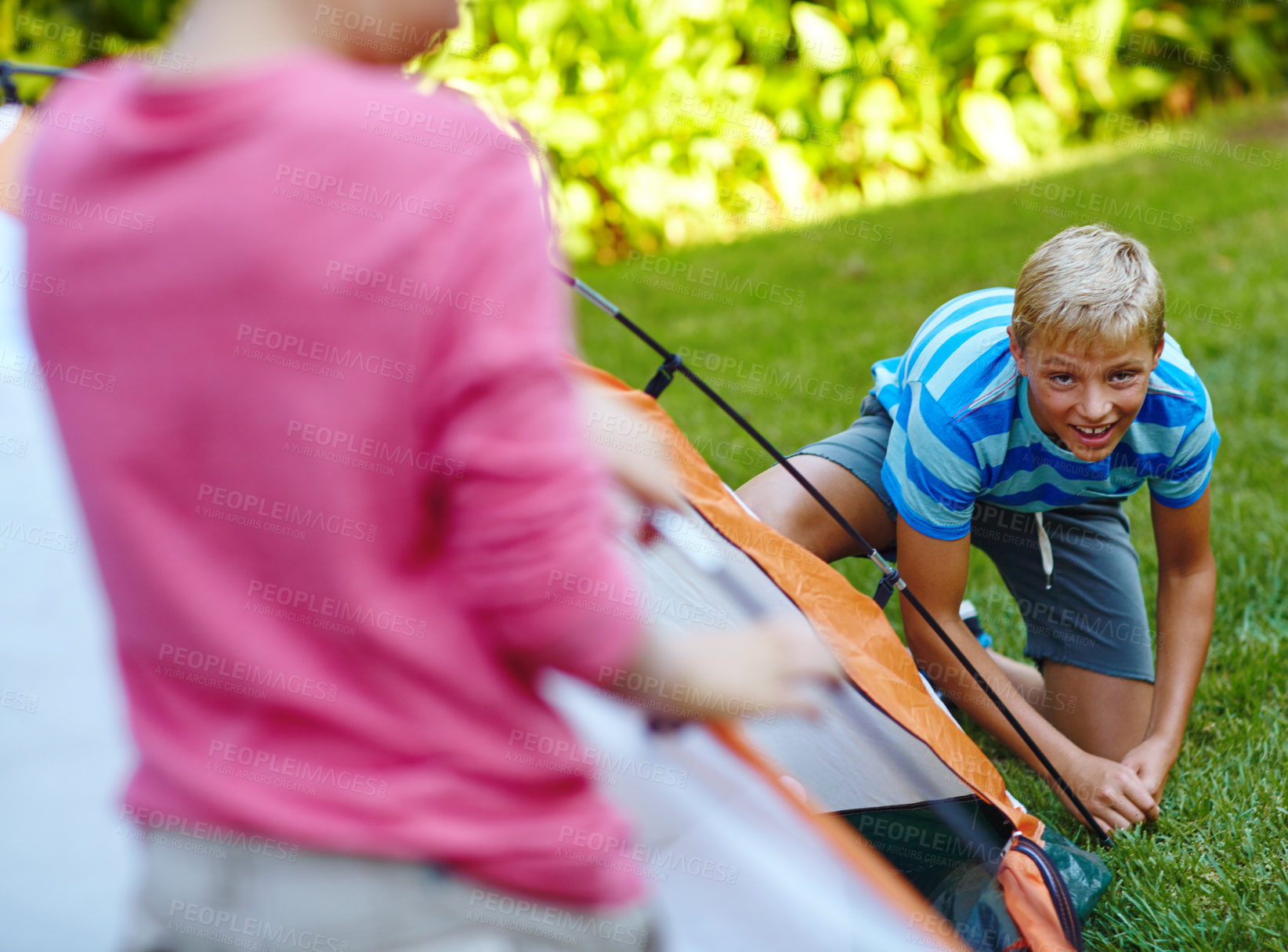 Buy stock photo Camping, kids and pitch tent outdoor for holiday adventure, gear safety or shelter preparation. Portrait, friends or boy with campsite set up in nature for weekend getaway, bonding or survival skills