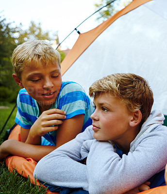 Buy stock photo Cropped shot of three young boys lying in their tent