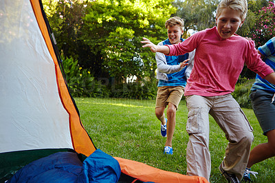 Buy stock photo Full length shot of three young boys running into their tent