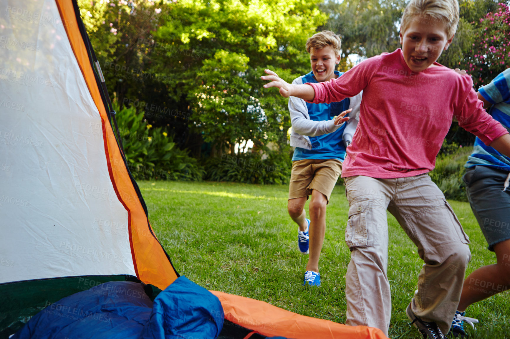 Buy stock photo Full length shot of three young boys running into their tent