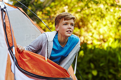 Buy stock photo Cropped shot of a young boy looking out of his tent