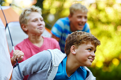 Buy stock photo Cropped shot of three young boys looking out of their tent