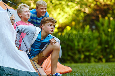 Buy stock photo Cropped shot of three young boys looking out of their tent