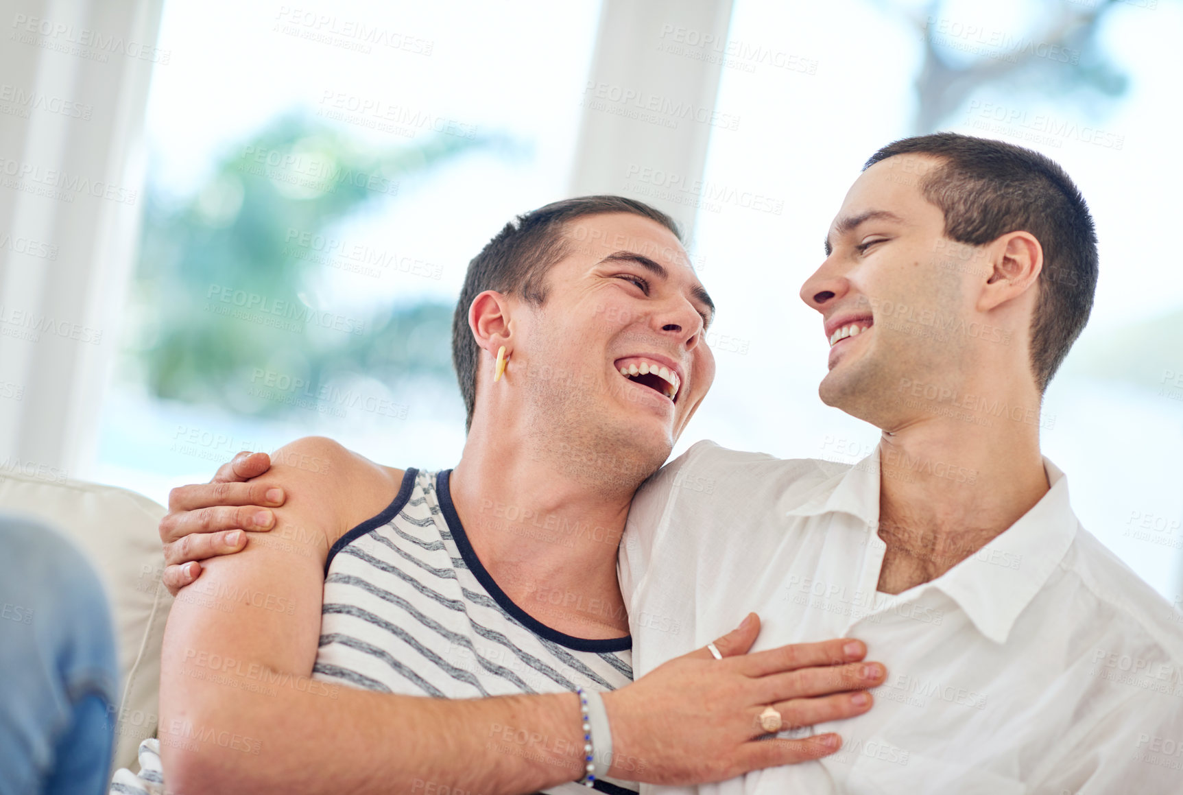 Buy stock photo Shot of a gay couple relaxing together at home