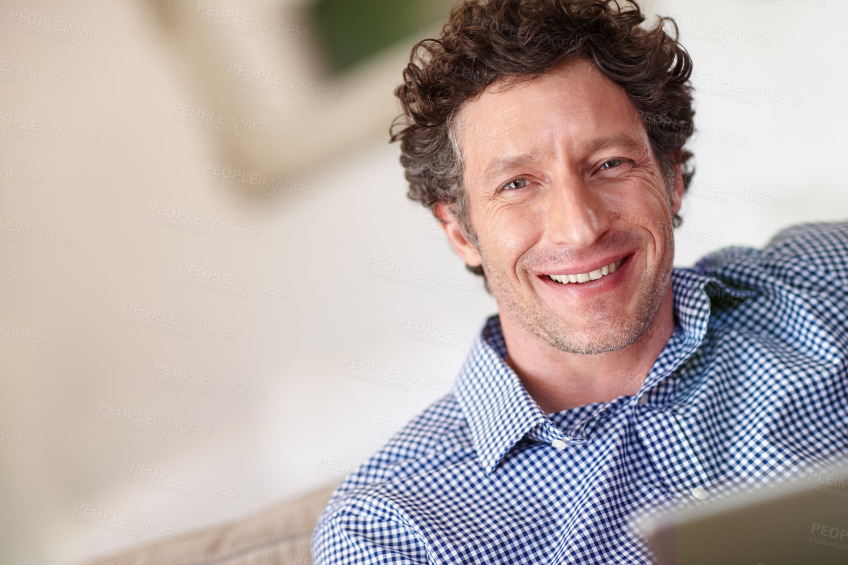 Buy stock photo Cropped portrait of a happy man using his tablet at home