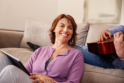 Buy stock photo Cropped shot of a woman using a digital tablet at home