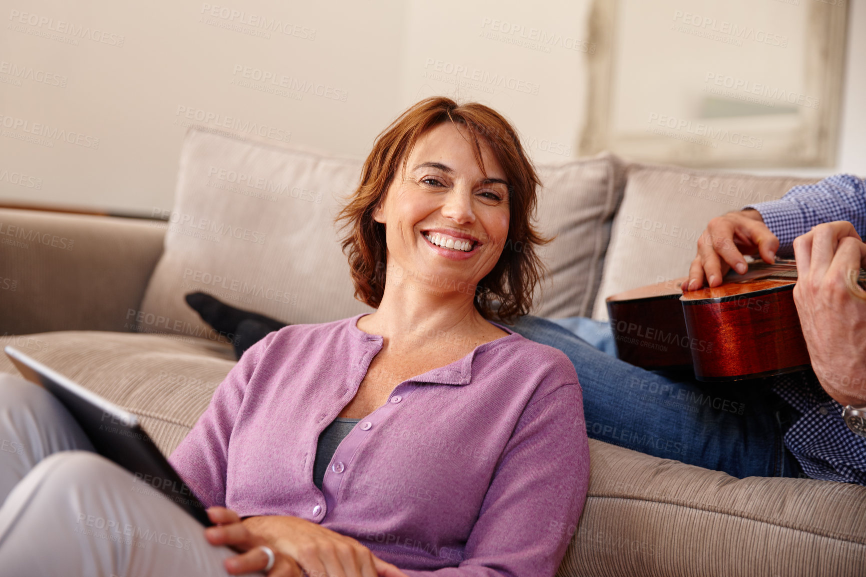 Buy stock photo Cropped shot of a woman using a digital tablet at home