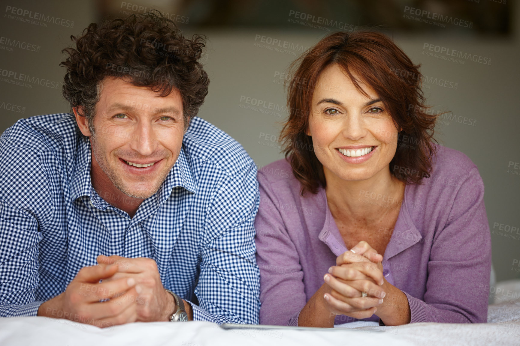 Buy stock photo Portrait of a couple lying on their bed